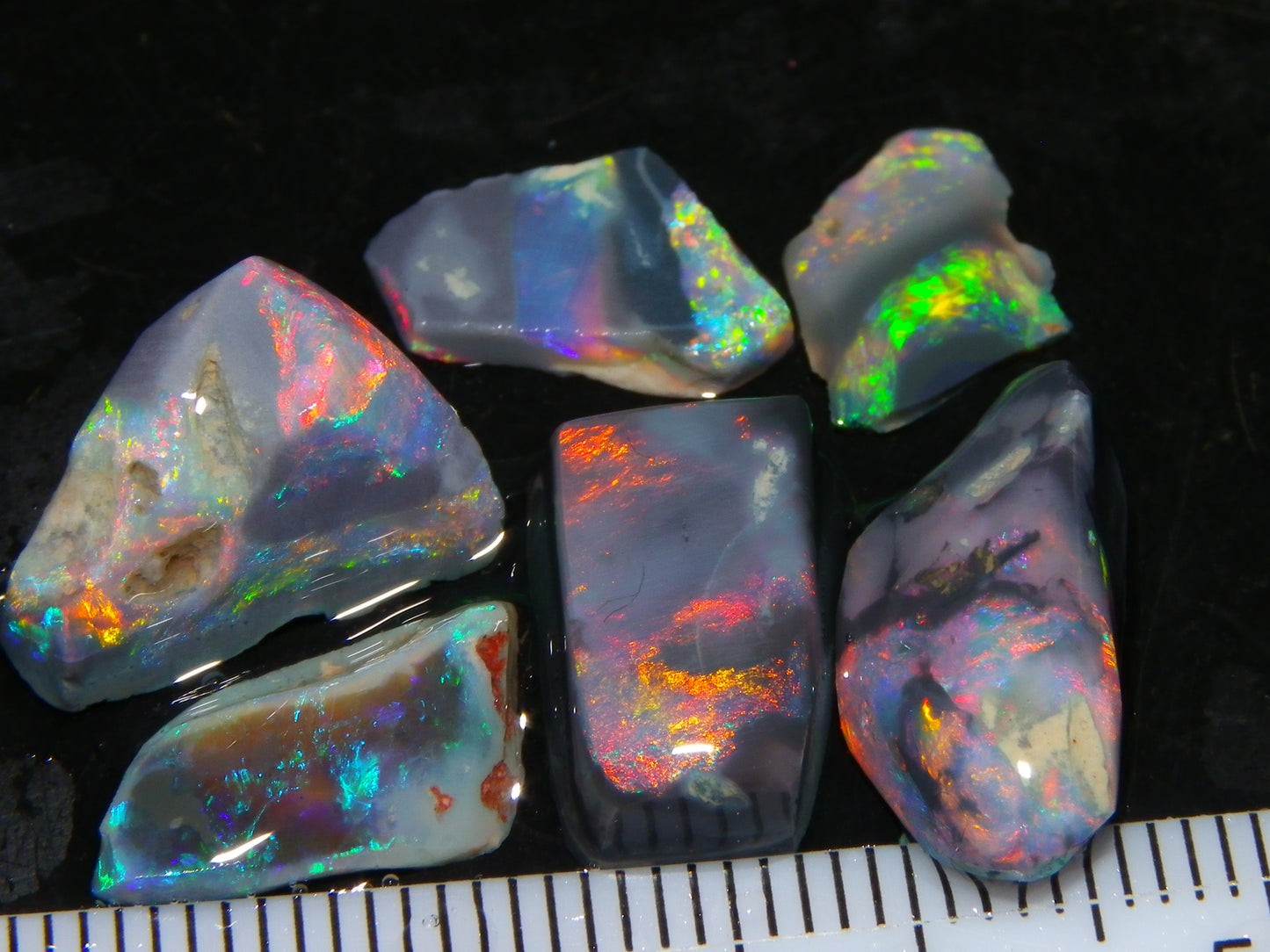 Nice Quality Rubbed Lightning Ridge Opal Parcel 18.04cts Dark Base Reds/Greens