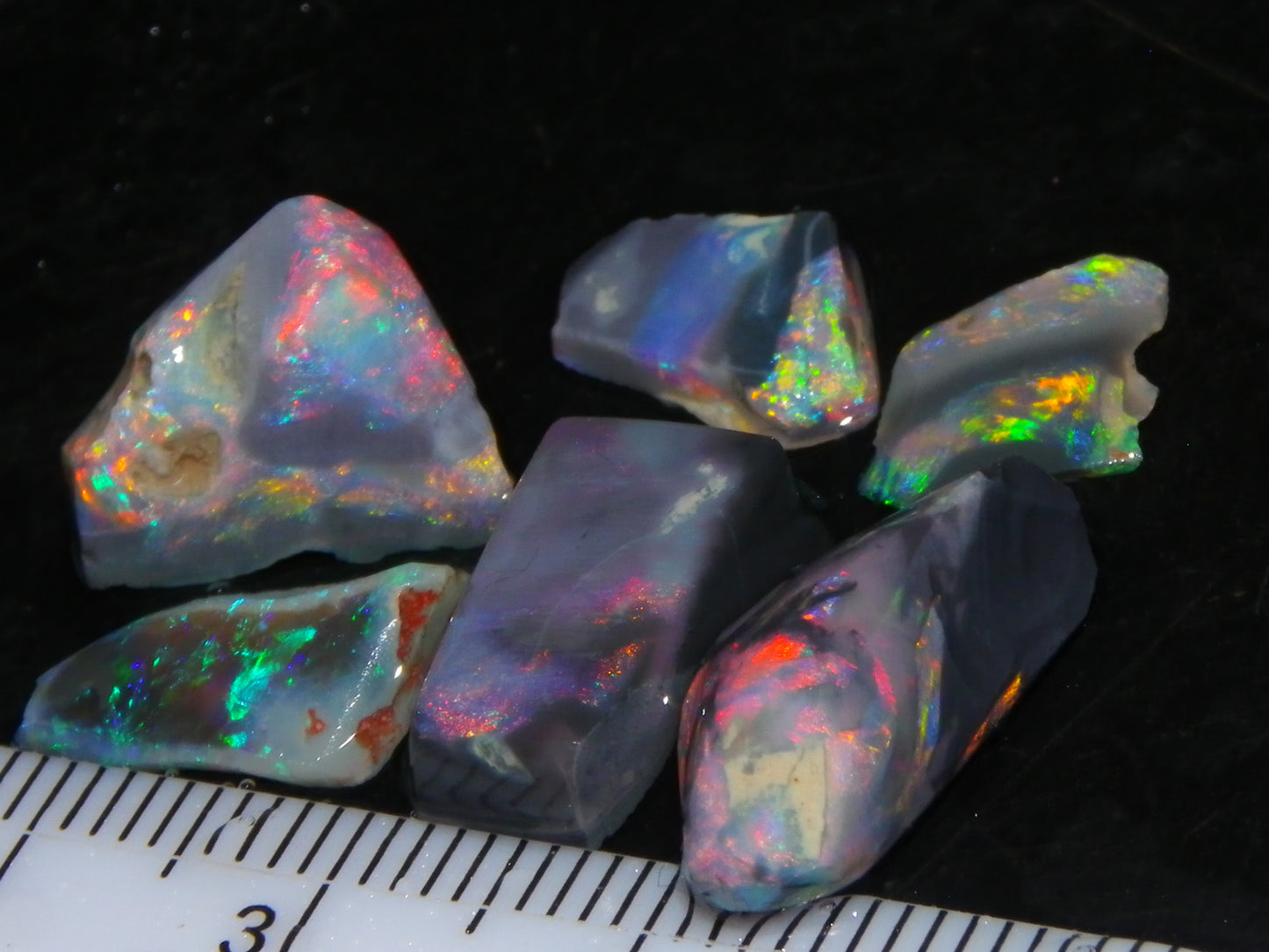 Nice Quality Rubbed Lightning Ridge Opal Parcel 18.04cts Dark Base Reds/Greens