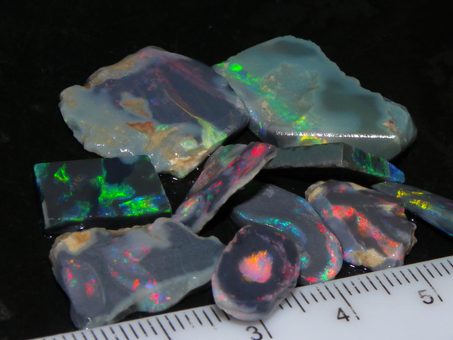 Nice Rough/Rubbed/Sliced Lightning Ridge Opal Parcel 32.9cts Red/Green Fires Dark Base